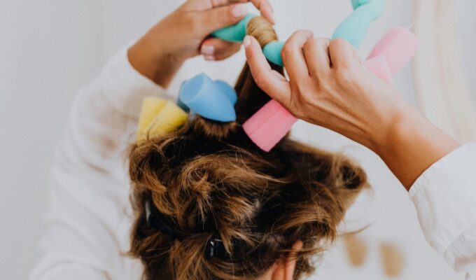 woman putting foam rollers in her hair