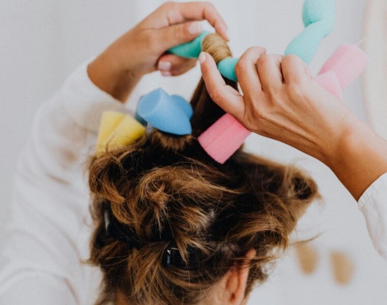 woman putting foam rollers in her hair