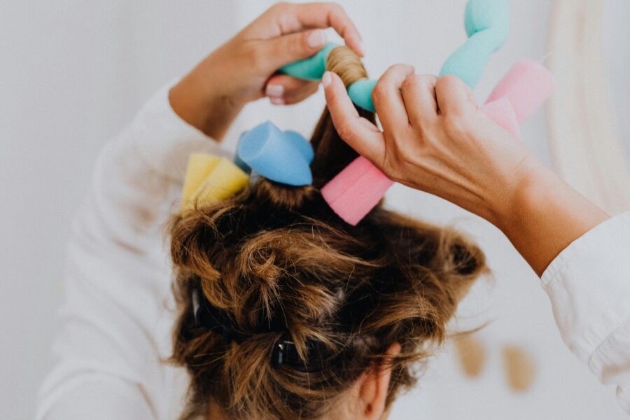 woman putting foam rollers in her hair