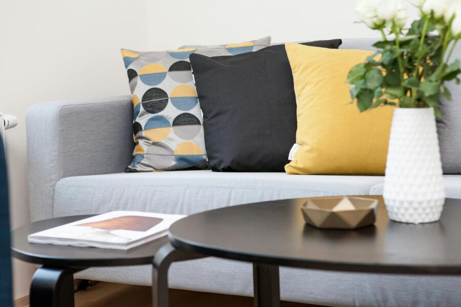 Cozy minimalist living room with neutral tones, soft lighting, layered textiles, and natural wood accents creating a calm and inviting space